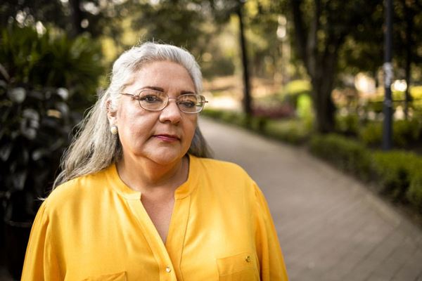 Older woman walking alone at a park
